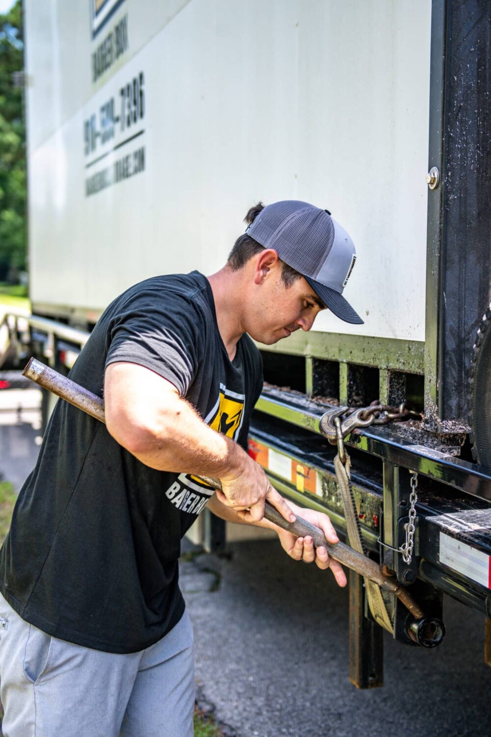Badger Box driver securing storage conttainer on trailer